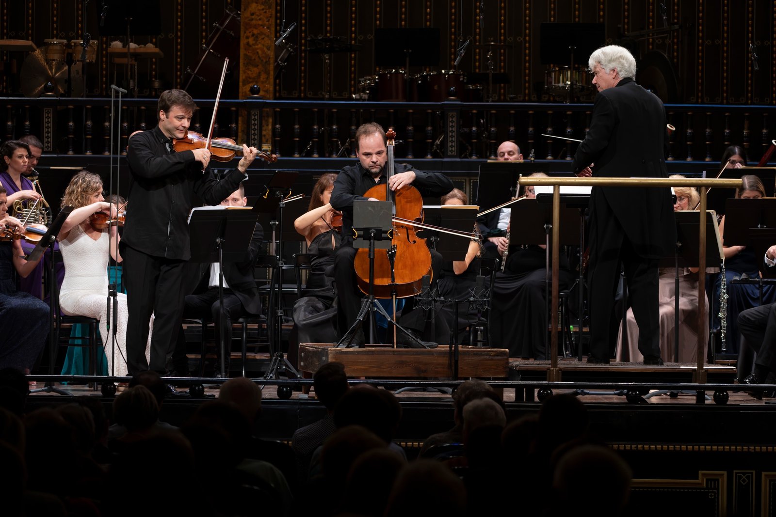 László Mező onstage with soloist and conductor in Budapest