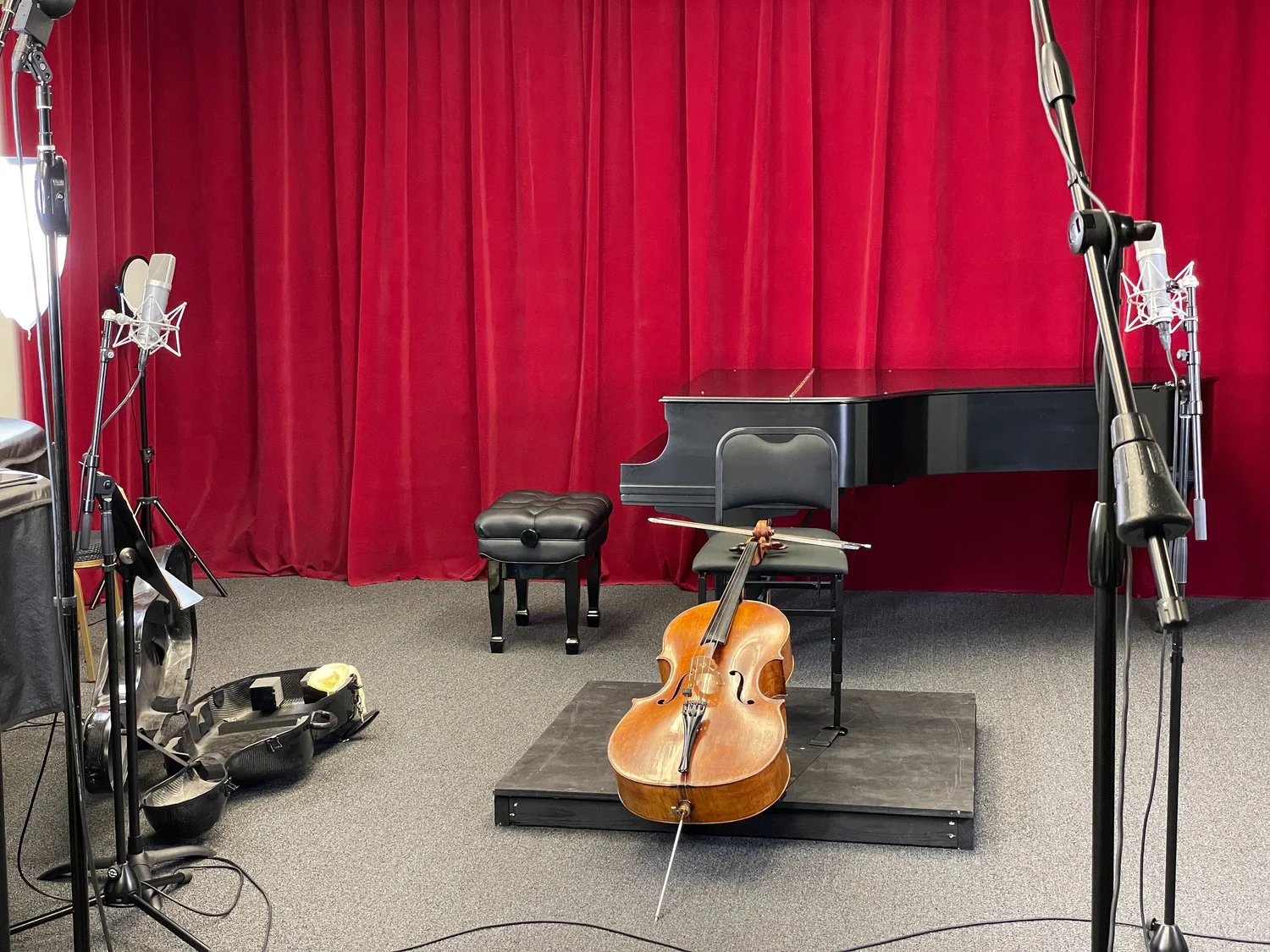 Cello recording session with piano and microphones